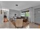 Cozy living room with terrazzo floors, large windows, and neutral decor at 472 Pine St, Tarpon Springs, FL 34689