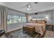 Serene main bedroom featuring terrazzo flooring, abundant natural light, and neutral color palette at 472 Pine St, Tarpon Springs, FL 34689