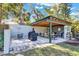 Outdoor kitchen and patio area equipped with a grill, dining table, and seating, perfect for entertaining at 472 Pine St, Tarpon Springs, FL 34689