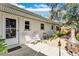 Side yard with gravel, a small garden, seating, and entry to the main house at 472 Pine St, Tarpon Springs, FL 34689