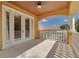 Home's balcony with decorative white fencing and overhead ceiling at 4873 Quill Ct, Palm Harbor, FL 34685