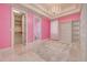 Charming bedroom with bright pink walls, built-in shelves, and a stylish chandelier at 4873 Quill Ct, Palm Harbor, FL 34685