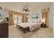 Staged bedroom features beautiful lighting, bed, furniture and balcony access at 4873 Quill Ct, Palm Harbor, FL 34685