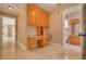 Hallway with desk nook, bathroom access and view of a room through an open door at 4873 Quill Ct, Palm Harbor, FL 34685