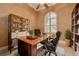 This home office features a large window, custom desk, shelving, and a comfortable leather chair at 4873 Quill Ct, Palm Harbor, FL 34685