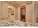 View into the kitchen through an arched doorway featuring a decorative wrought iron pantry door at 4873 Quill Ct, Palm Harbor, FL 34685