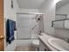 Bathroom with updated sliding shower doors, tiled floor, and vanity with solid surface counter at 5925 Shore S Blvd # 406, Gulfport, FL 33707