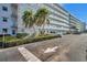 Exterior view of condominium building, showing well-maintained landscaping and reserved parking at 5925 Shore S Blvd # 406, Gulfport, FL 33707
