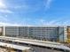 This building has spacious balconies, white railings, and covered parking to provide comfort, convenience, and accessibility at 5925 Shore S Blvd # 406, Gulfport, FL 33707