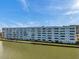 Condominium building with a waterfront view and clear blue sky at 5925 Shore S Blvd # 406, Gulfport, FL 33707