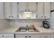 Well-lit kitchen sink and countertop with white cabinetry offer ample space for cooking at 5925 Shore S Blvd # 406, Gulfport, FL 33707