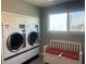 Well maintained community laundry room provides washer and dryers with a peaceful water view at 5925 Shore S Blvd # 406, Gulfport, FL 33707