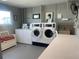 Clean community laundry room provides multiple washers and dryers, plus folding table at 5925 Shore S Blvd # 406, Gulfport, FL 33707