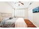 Serene bedroom with tray ceiling, wood floors, plantation shutters, a tv, and a closet at 6040 Fishhawk Crossing Blvd # 6040, Lithia, FL 33547