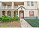 Inviting condo exterior featuring a red front door and charming stone accents at 6040 Fishhawk Crossing Blvd # 6040, Lithia, FL 33547