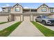 Townhome exterior with a car parked in front of a garage at 6040 Fishhawk Crossing Blvd # 6040, Lithia, FL 33547