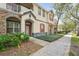 Townhome exterior with stone accents, red door and flower bed at 6040 Fishhawk Crossing Blvd # 6040, Lithia, FL 33547