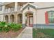 Charming front entrance with a red door, stone accents, and well-maintained landscaping at 6040 Fishhawk Crossing Blvd # 6040, Lithia, FL 33547