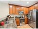 Well-equipped kitchen featuring granite countertops, stainless steel appliances, and wooden cabinetry at 6040 Fishhawk Crossing Blvd # 6040, Lithia, FL 33547