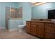 Bright bathroom featuring a glass-enclosed shower and a wooden vanity with granite countertops at 6222 Kingbird Manor Dr, Lithia, FL 33547