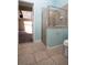 Bathroom featuring a glass-enclosed shower and an exit to the exterior of the home at 6222 Kingbird Manor Dr, Lithia, FL 33547