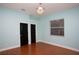 Charming bedroom with blue walls, dark wood doors, and bamboo floors at 6222 Kingbird Manor Dr, Lithia, FL 33547