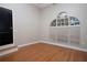 Bedroom featuring hardwood floors and an arched window for natural light at 6222 Kingbird Manor Dr, Lithia, FL 33547