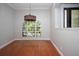 Dining Room features hardwood floors, a large window, crown molding and modern light fixture at 6222 Kingbird Manor Dr, Lithia, FL 33547