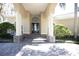 Inviting front entrance showcasing a beautiful glass door with stone accents and manicured landscaping at 6222 Kingbird Manor Dr, Lithia, FL 33547