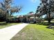 Beautiful home boasts a long driveway, mature landscaping, and stone accents on facade at 6222 Kingbird Manor Dr, Lithia, FL 33547