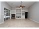 Spacious living room with a ceiling fan, fireplace, and built-in shelving at 6222 Kingbird Manor Dr, Lithia, FL 33547