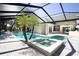 Sparkling pool and hot tub in a screened enclosure with mature palm trees at 6222 Kingbird Manor Dr, Lithia, FL 33547