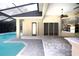 Screened pool area with brick pavers, outdoor lighting, and access to the home at 6222 Kingbird Manor Dr, Lithia, FL 33547