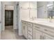 Bathroom featuring double vanity with stone countertop and a walk-in closet in the background at 6307 113Th E Ter, Parrish, FL 34219