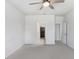 Neutral bedroom showcasing a ceiling fan, carpet, and a doorway leading to a walk-in closet at 6307 113Th E Ter, Parrish, FL 34219