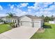 Beautiful exterior view of home showing a three car garage, lush landscaping and a paver driveway at 6307 113Th E Ter, Parrish, FL 34219