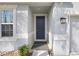 Entryway showcasing a modern front door with sidelight, elegant lighting and stone accents at 6307 113Th E Ter, Parrish, FL 34219