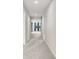 Bright hallway features neutral walls and flooring, leading to living areas at 6307 113Th E Ter, Parrish, FL 34219