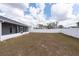 Backyard with white vinyl fence providing privacy and a screened in porch to enjoy the outdoors at 7056 Landover Blvd, Spring Hill, FL 34608