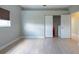 Empty bedroom with hardwood floors, one window, closet, and neutral paint colors at 7056 Landover Blvd, Spring Hill, FL 34608