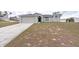 Attractive single-story home with a two-car garage, framed by a well-kept front lawn and landscaping at 7056 Landover Blvd, Spring Hill, FL 34608