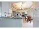 Well-lit kitchen featuring stainless steel appliances, a granite countertop island, and a dining area at 7056 Landover Blvd, Spring Hill, FL 34608