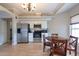 Well-lit kitchen featuring stainless steel appliances, granite countertops, and a dining area at 7056 Landover Blvd, Spring Hill, FL 34608