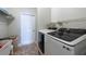 Efficient laundry room with shelving and modern appliances at 7056 Landover Blvd, Spring Hill, FL 34608