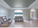 Bright living room featuring tray ceiling, modern furniture and large windows that let in plenty of light at 7056 Landover Blvd, Spring Hill, FL 34608