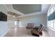 Spacious living room with natural light, tray ceiling and neutral paint, complete with comfortable furniture at 7056 Landover Blvd, Spring Hill, FL 34608