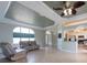 Bright living room featuring tray ceiling, modern furniture, open concept to kitchen and large windows at 7056 Landover Blvd, Spring Hill, FL 34608