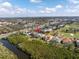 An aerial view highlighting the property's proximity to a golf course and waterways at 7284 Pebble Beach Ln, Seminole, FL 33777