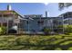 A tranquil screened-in back porch with a backyard view and partial view of the pool at 7284 Pebble Beach Ln, Seminole, FL 33777