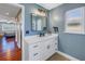 Bathroom vanity with a white counter and dark fixtures, with a peek into the bedroom at 7284 Pebble Beach Ln, Seminole, FL 33777